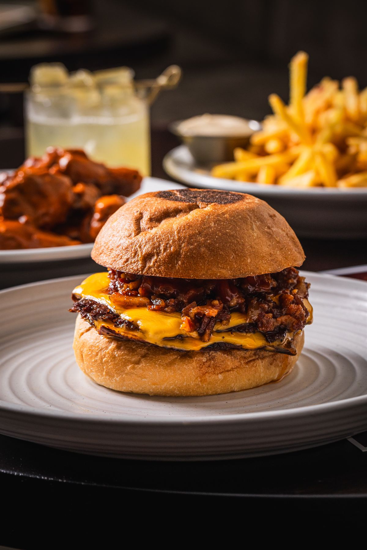 The Burger Victoria — double smashed patties, bacon jam, cheese, pickles and mustard mayo on a potato bun